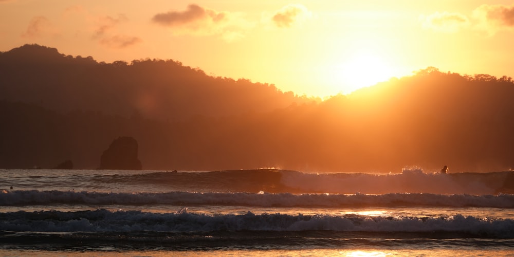 a person riding a surfboard on a wave in the ocean