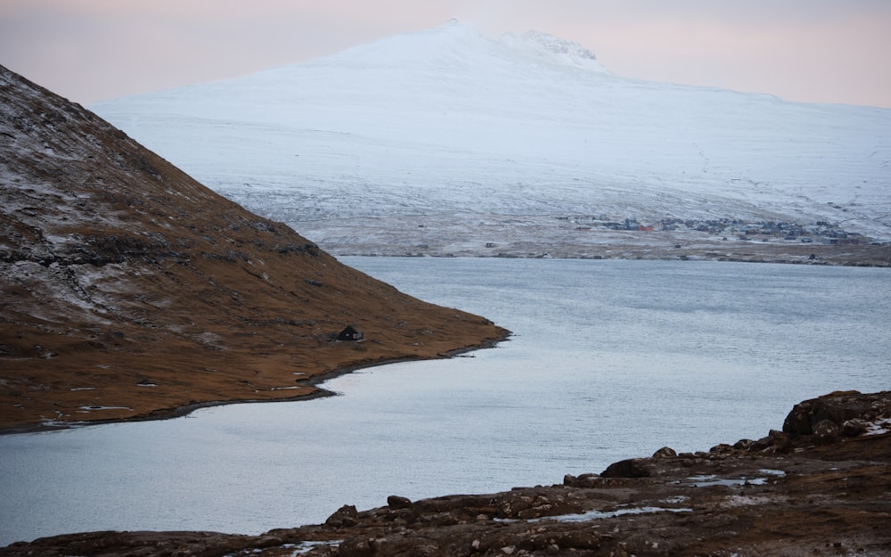 a mountain with a body of water in the foreground