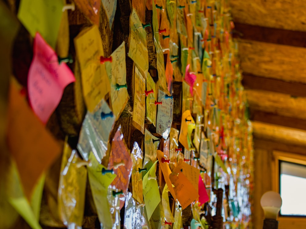 a wall with a lot of different colored papers on it