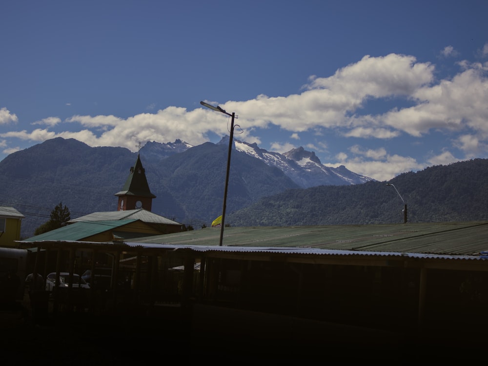 a view of a mountain range with a church in the foreground