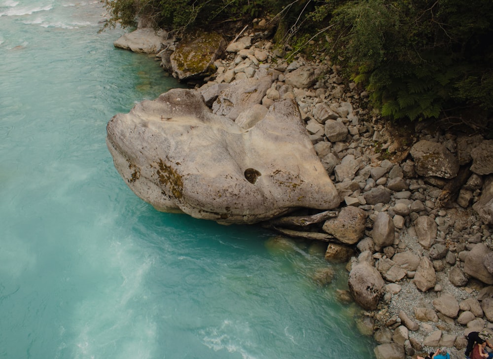 a group of people standing next to a river