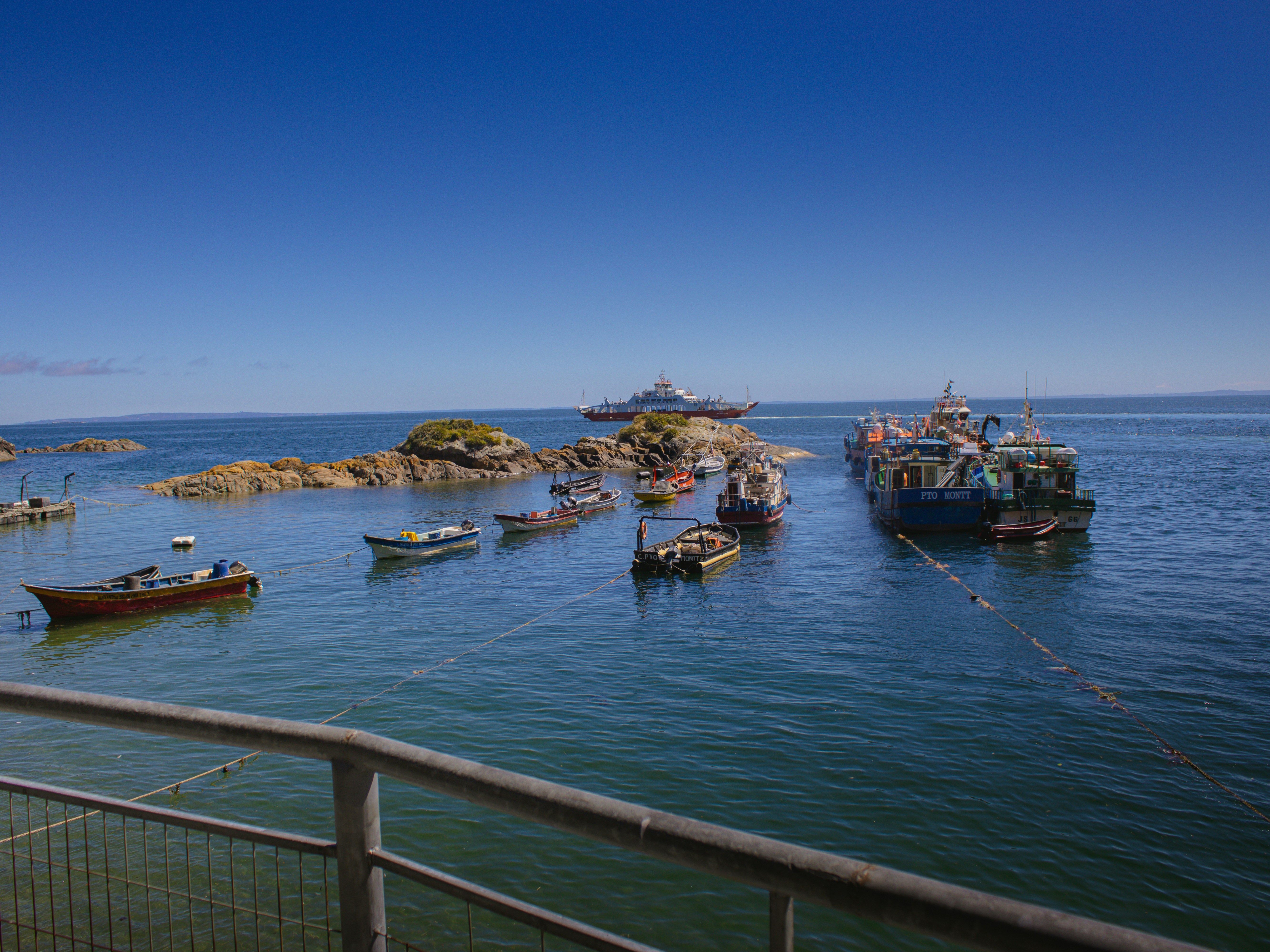 a group of boats floating on top of a body of water