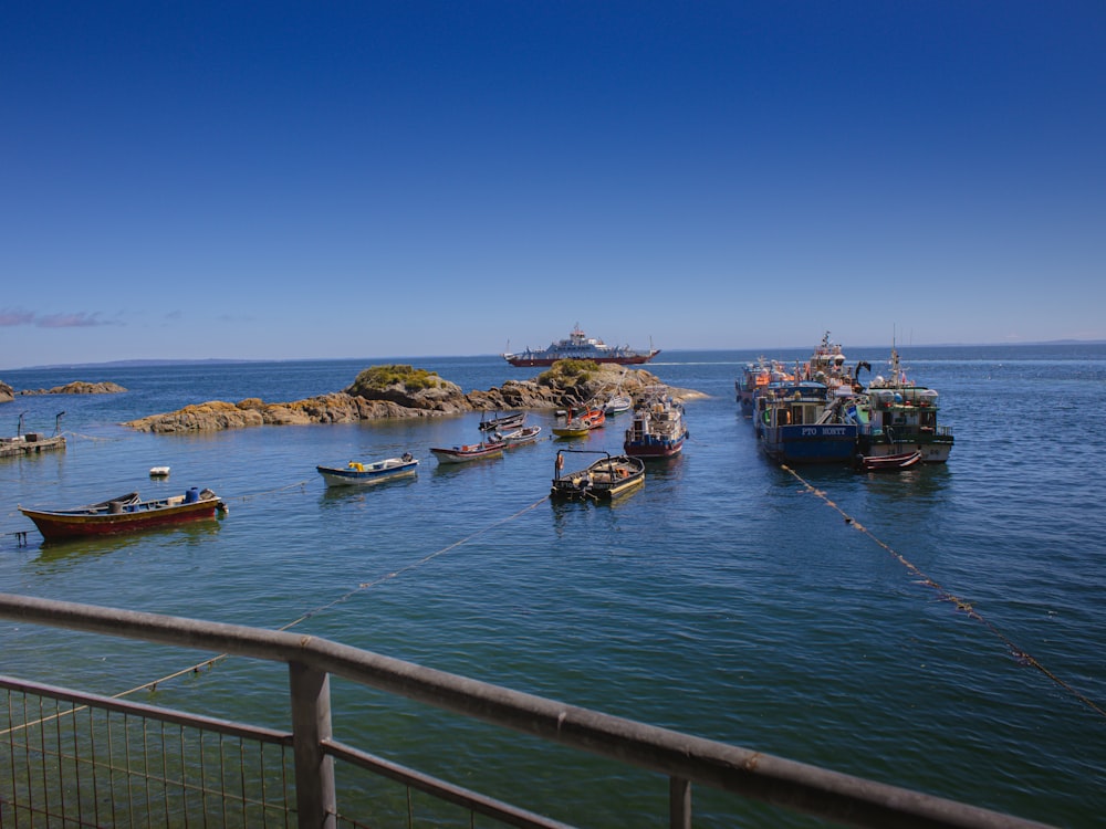 a group of boats floating on top of a body of water