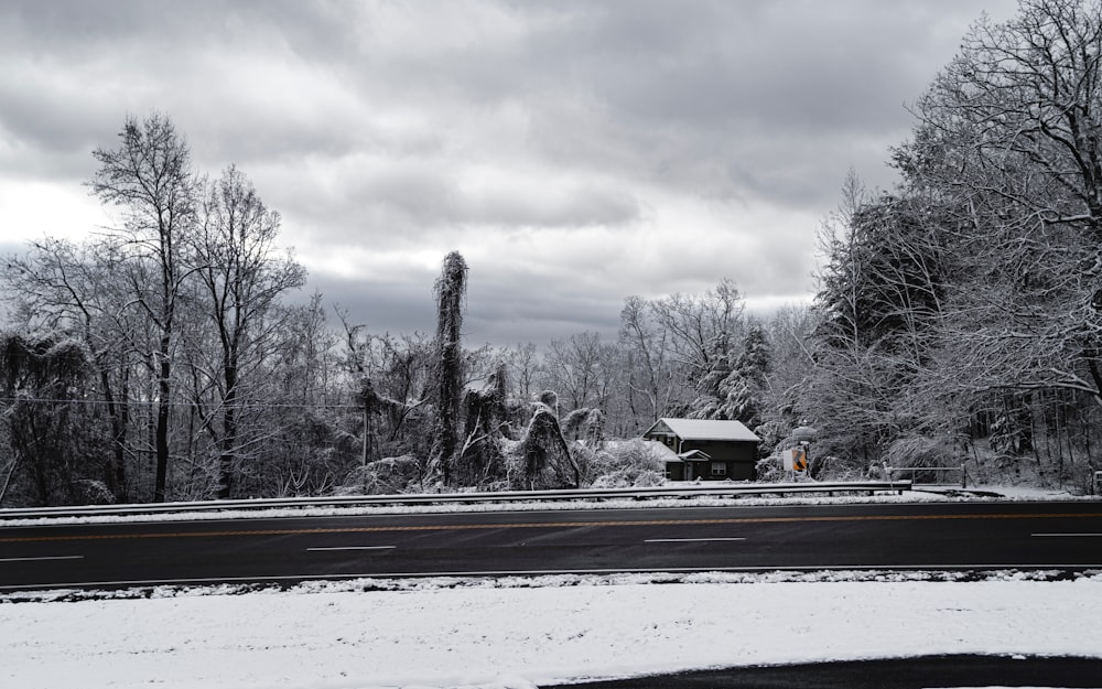 a snowy road with a stop sign in the foreground