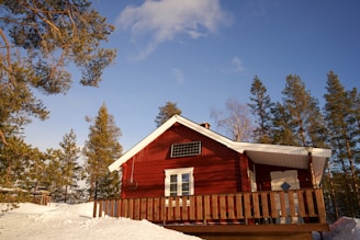 a remote red house with a solar panel