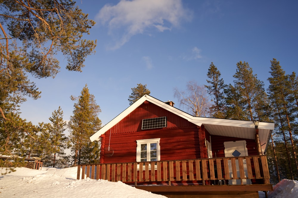 a red house with a porch and a wooden fence