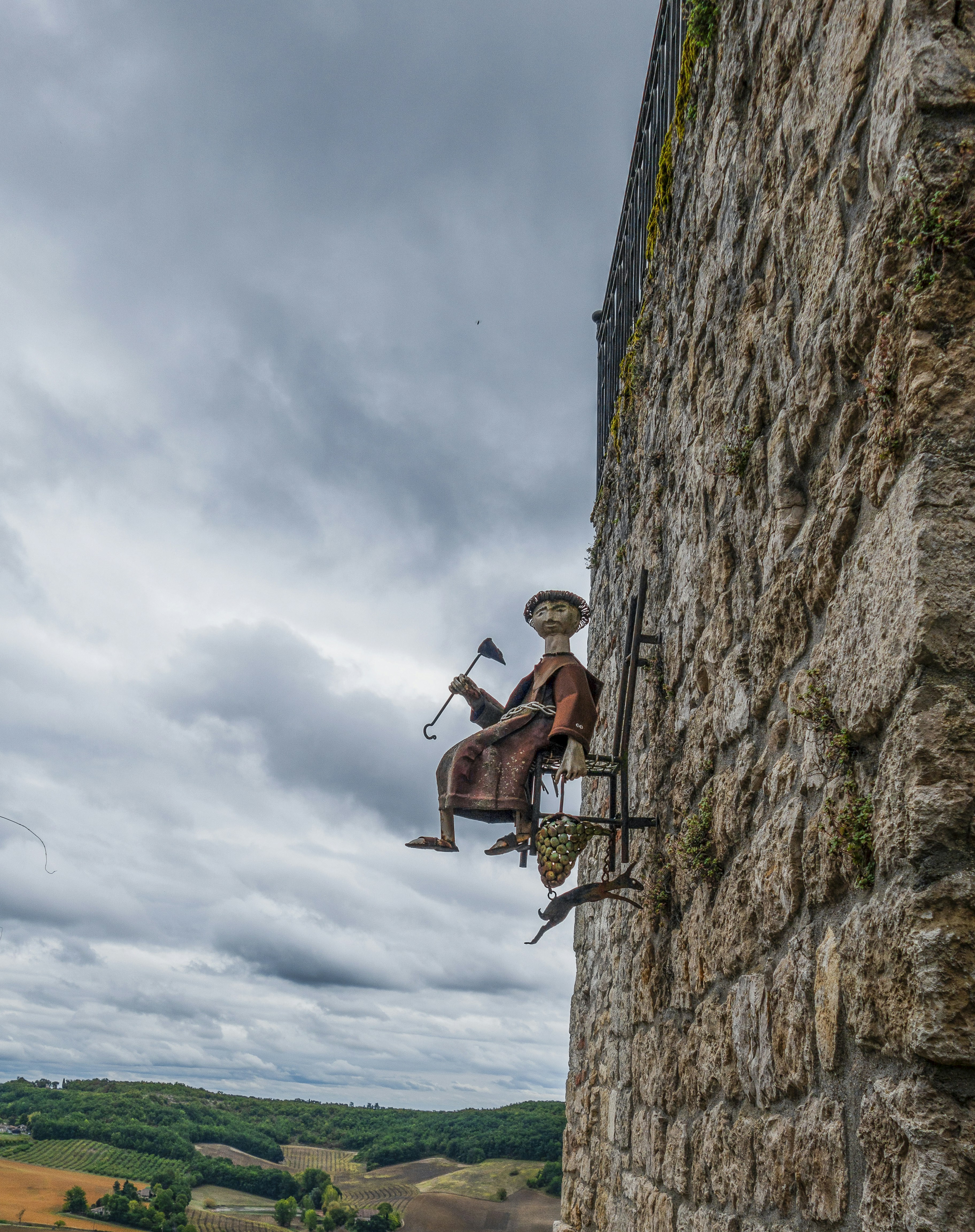a statue of a man playing a musical instrument on the side of a building