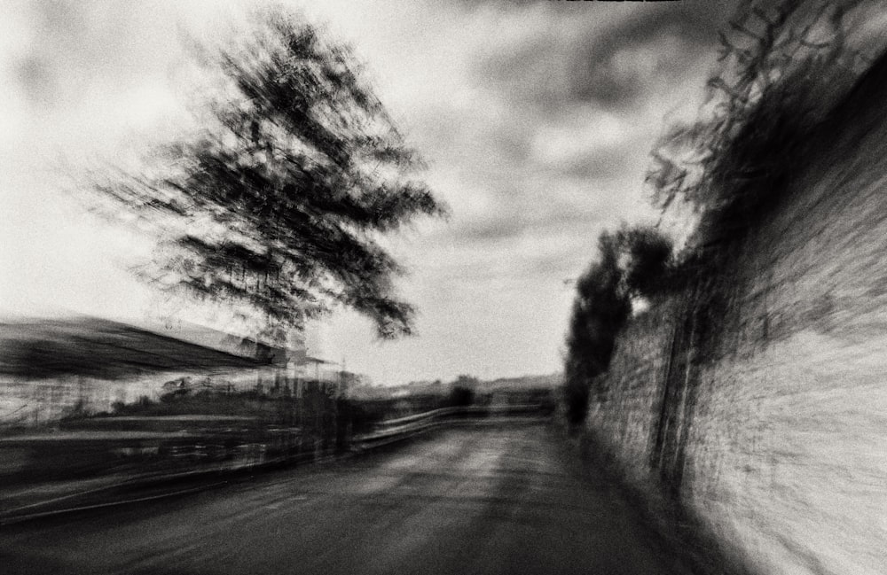 a blurry photo of a road with trees