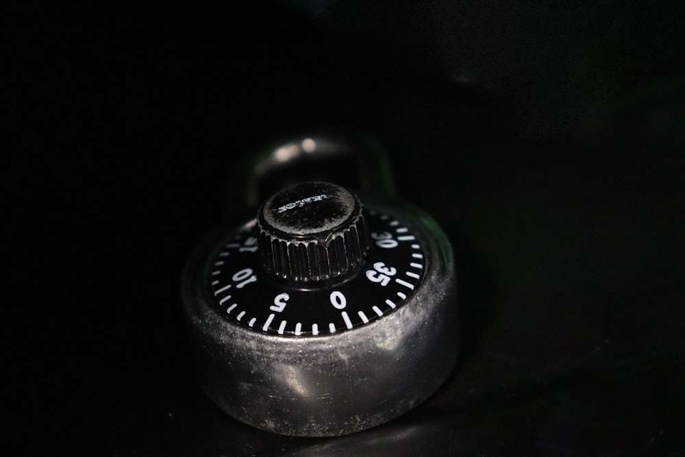 a close up of a combination lock on a black surface