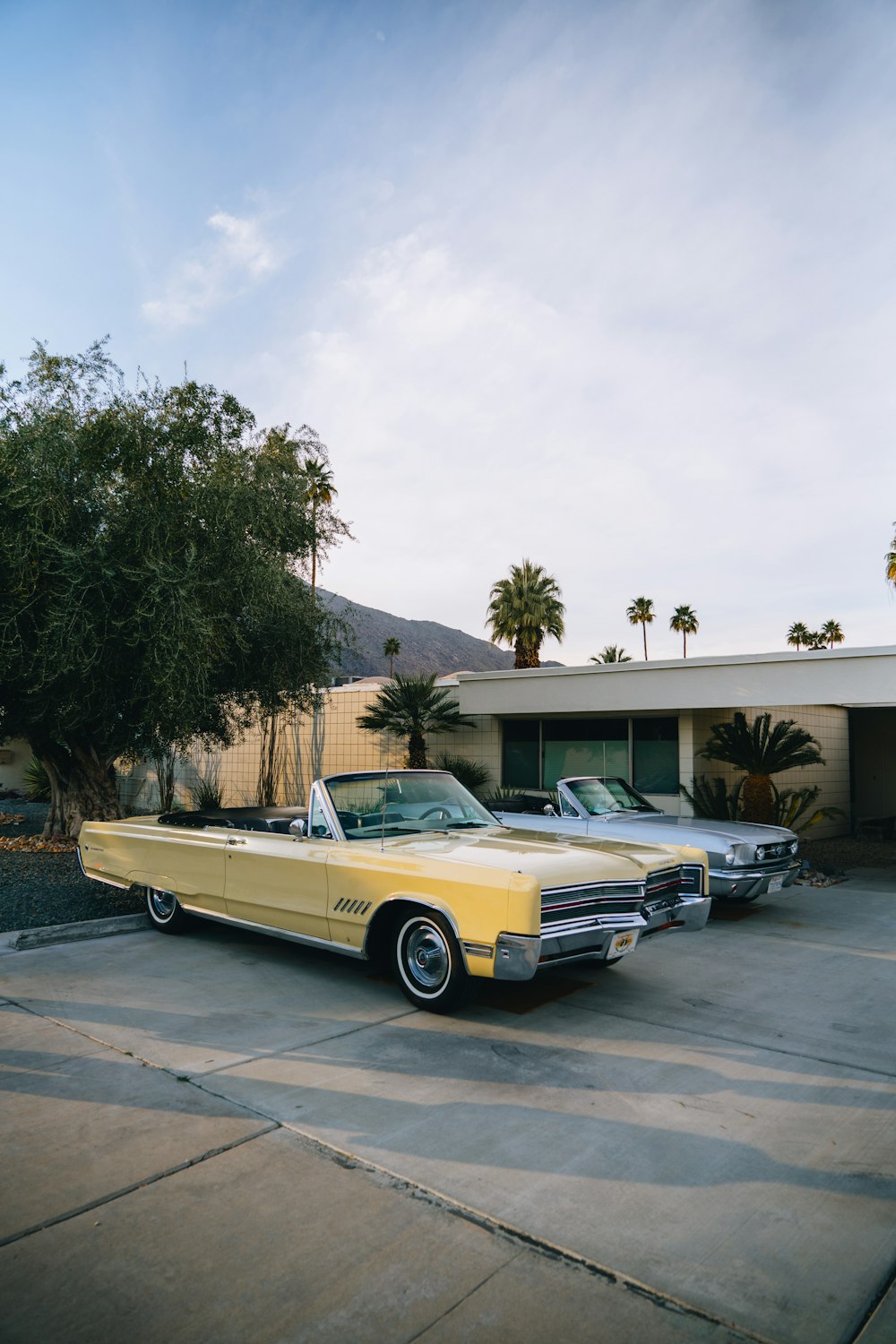 a yellow car parked in front of a house