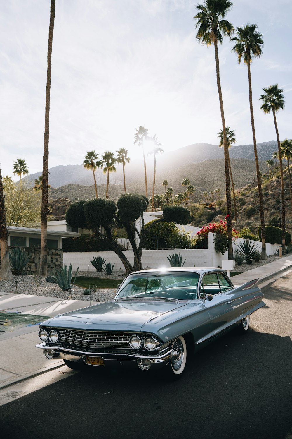 a classic car parked on the side of the road