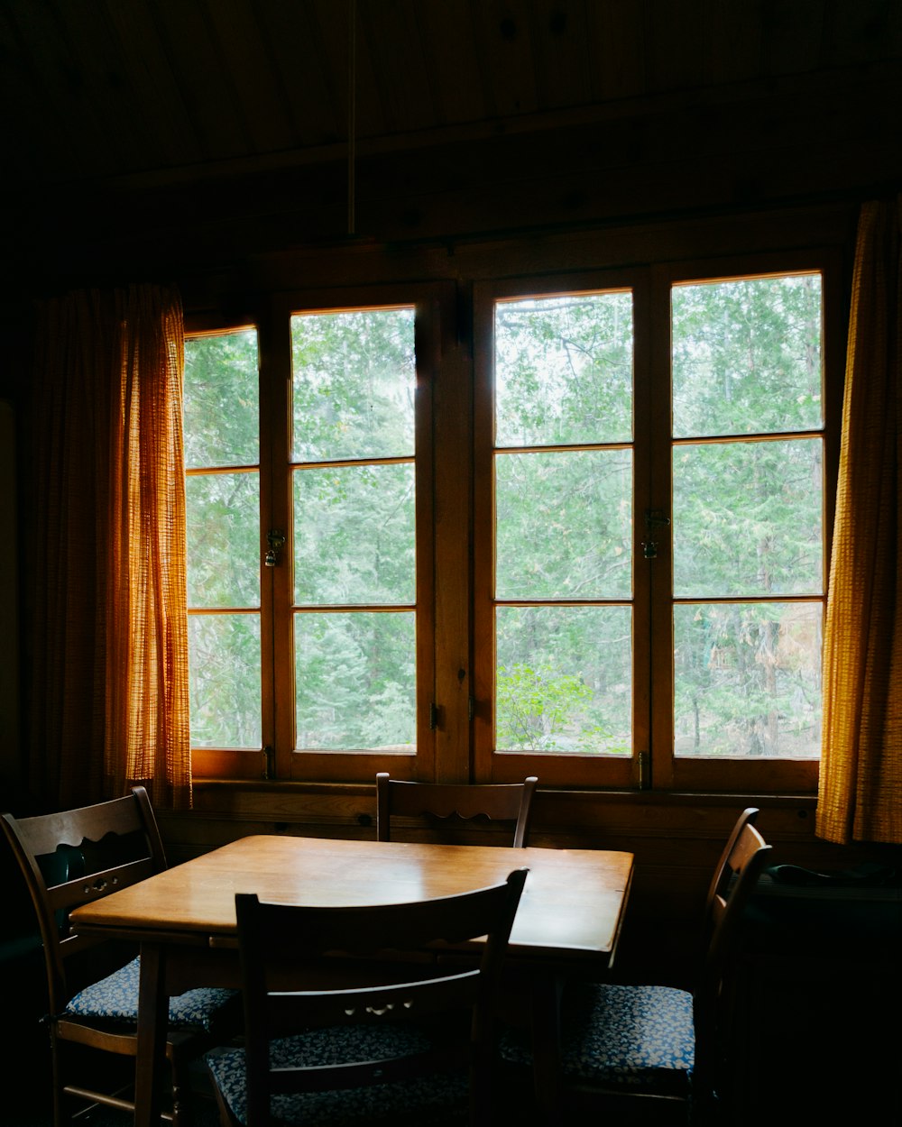 a table and chairs in front of a window
