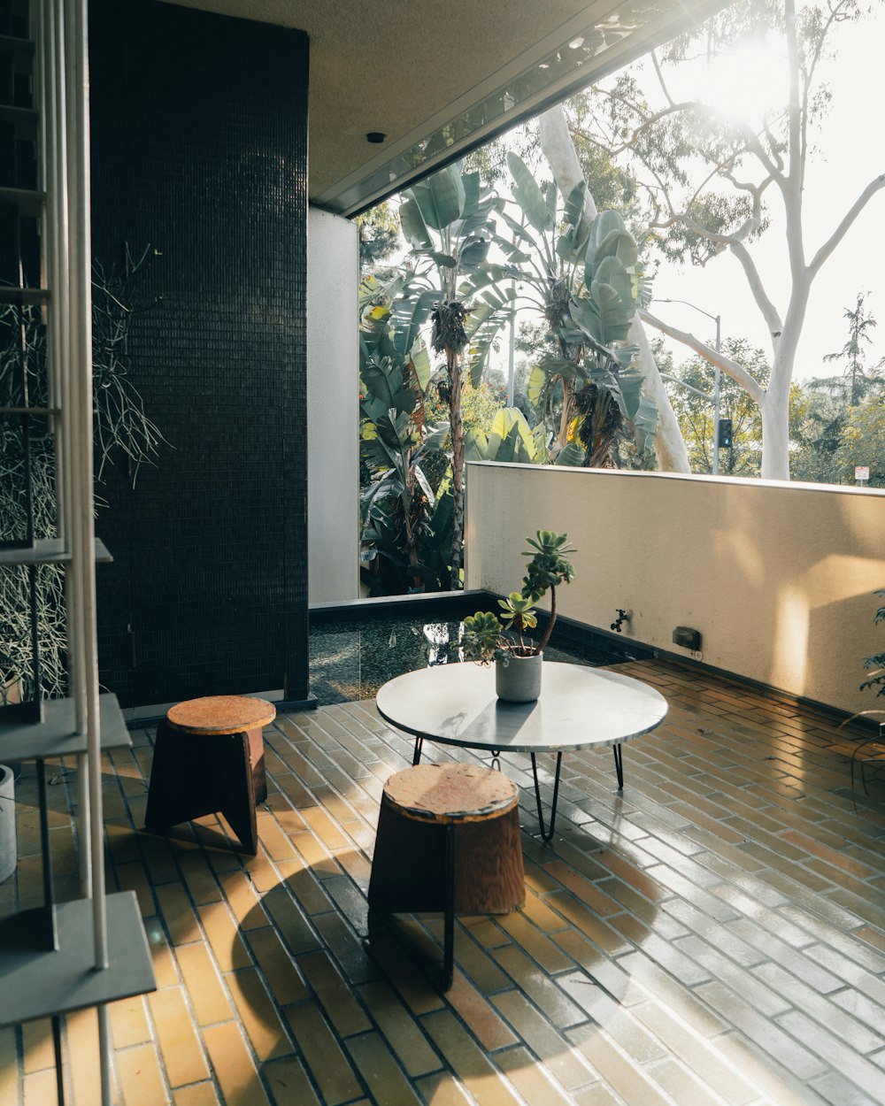 a living room with a table and two stools