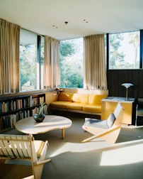 a living room filled with furniture and a large window