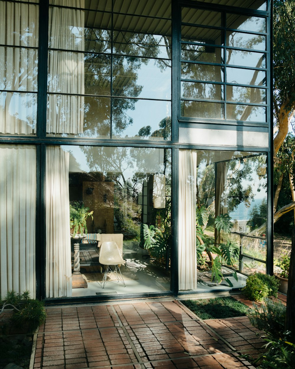 a glass walled patio with a table and chairs