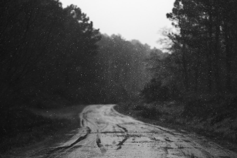 a black and white photo of a snowy road