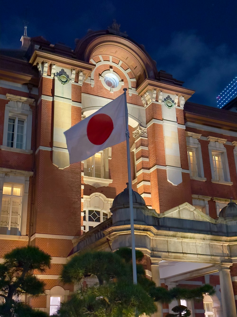 a japanese flag flying in front of a building