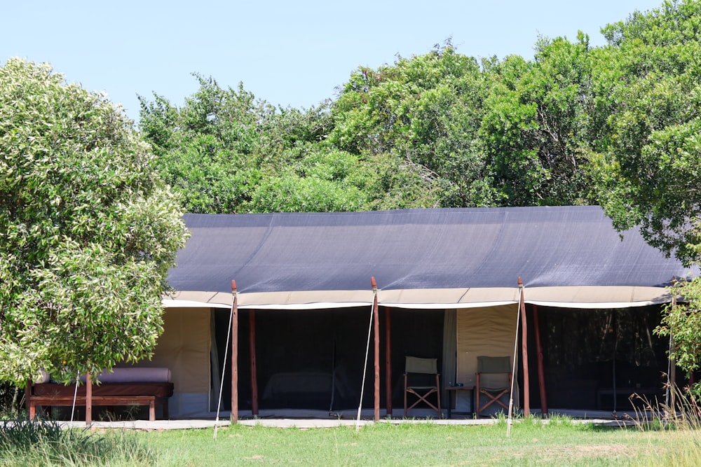 a tent set up in the middle of a field