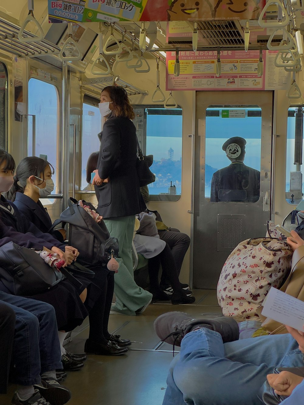 a group of people sitting on a train next to each other