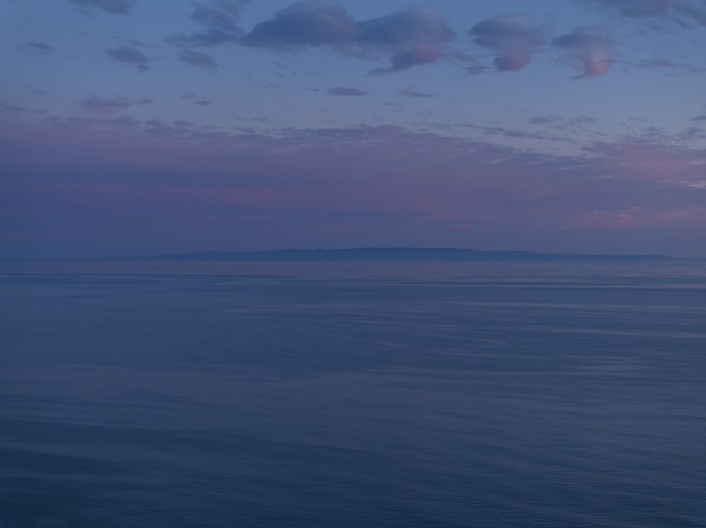 a large body of water under a cloudy sky