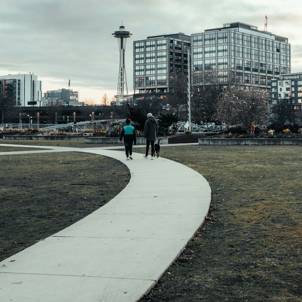 a couple of people that are walking down a path