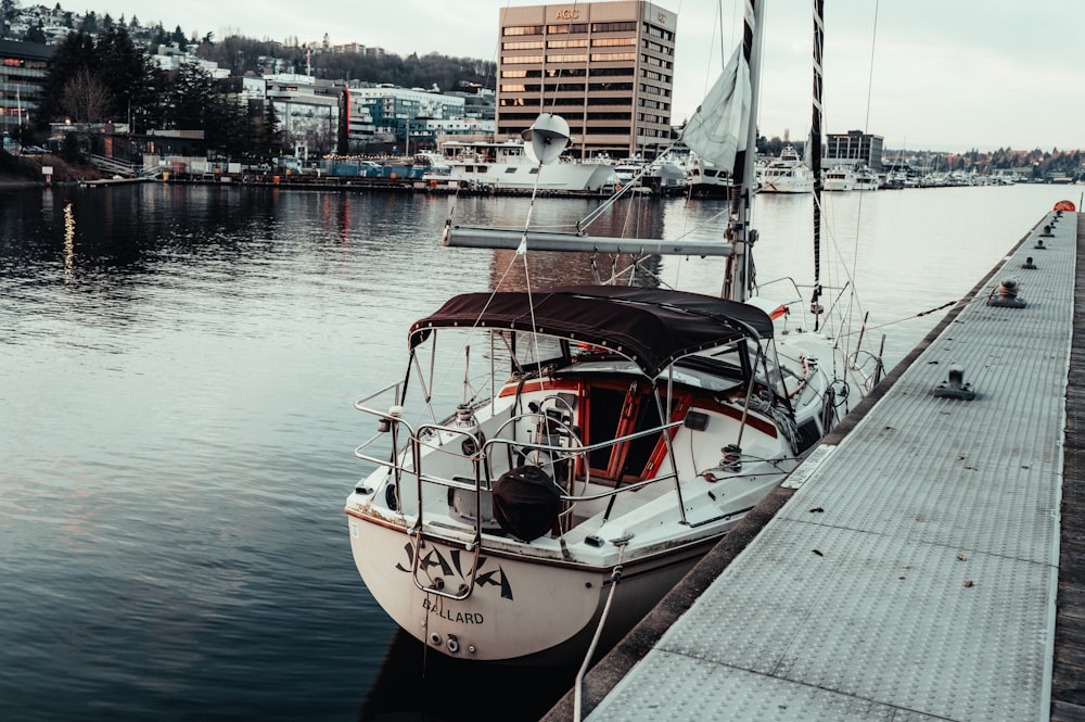 a sailboat docked at a dock in a harbor