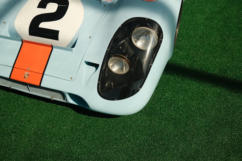 a close up of a race car on a grass field