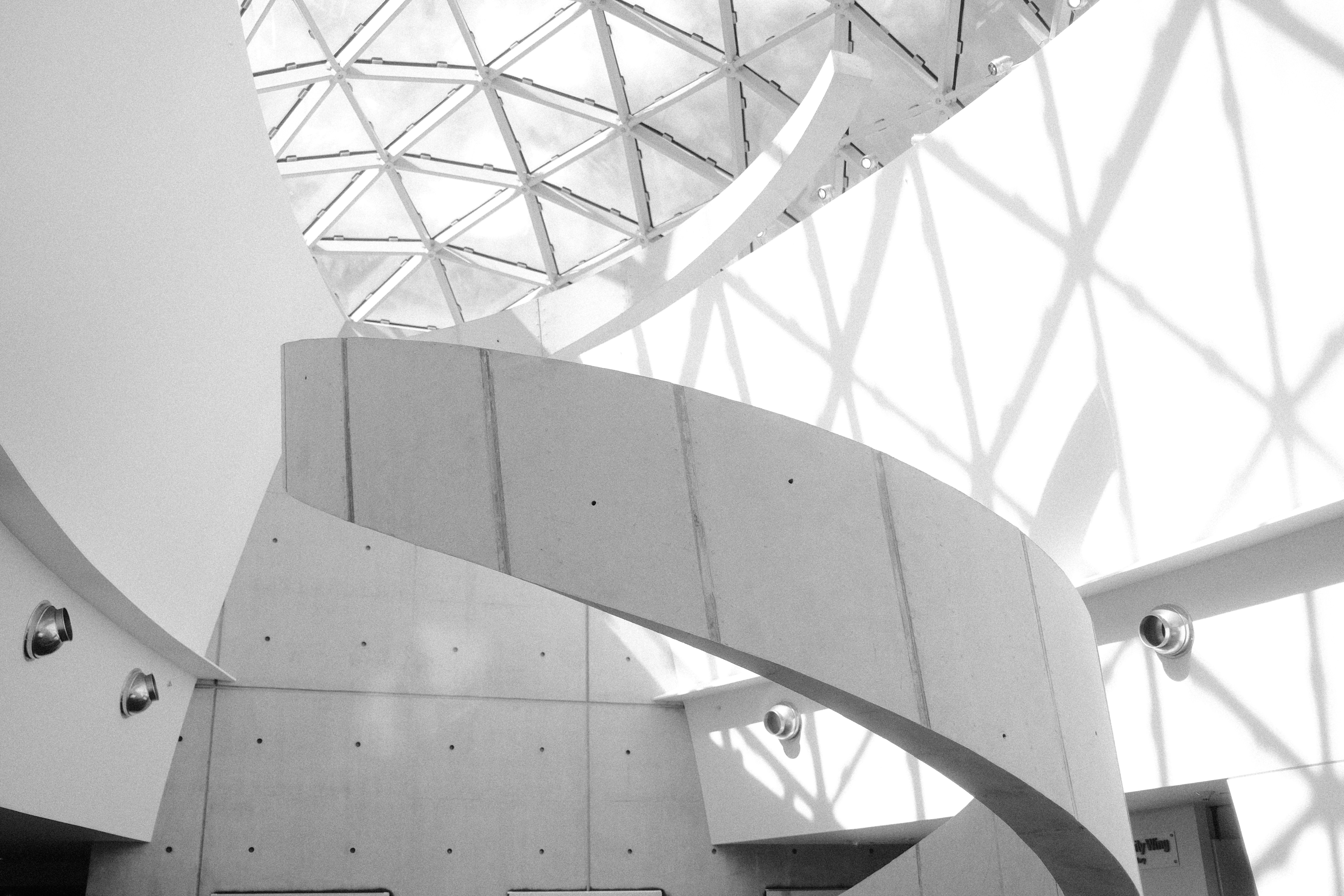 a black and white photo of a spiral staircase