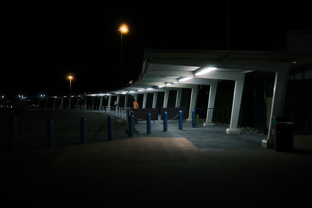 a row of white pillars sitting next to a parking lot