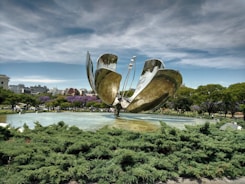 a large metal sculpture in the middle of a park