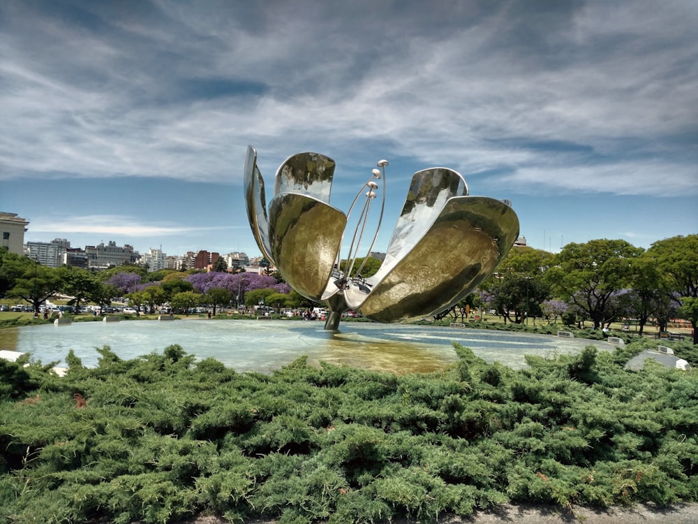 a large metal sculpture in the middle of a park