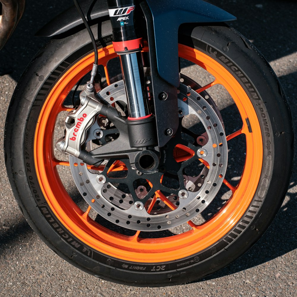 a close up of a motorcycle tire with orange rims