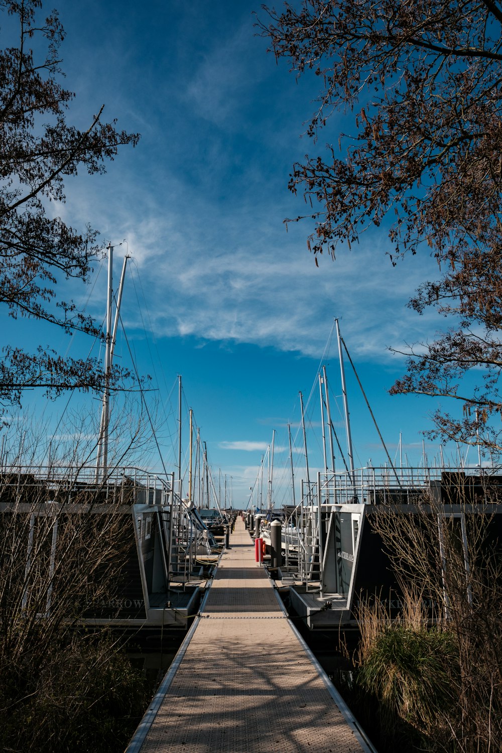 a long dock with many boats in the water