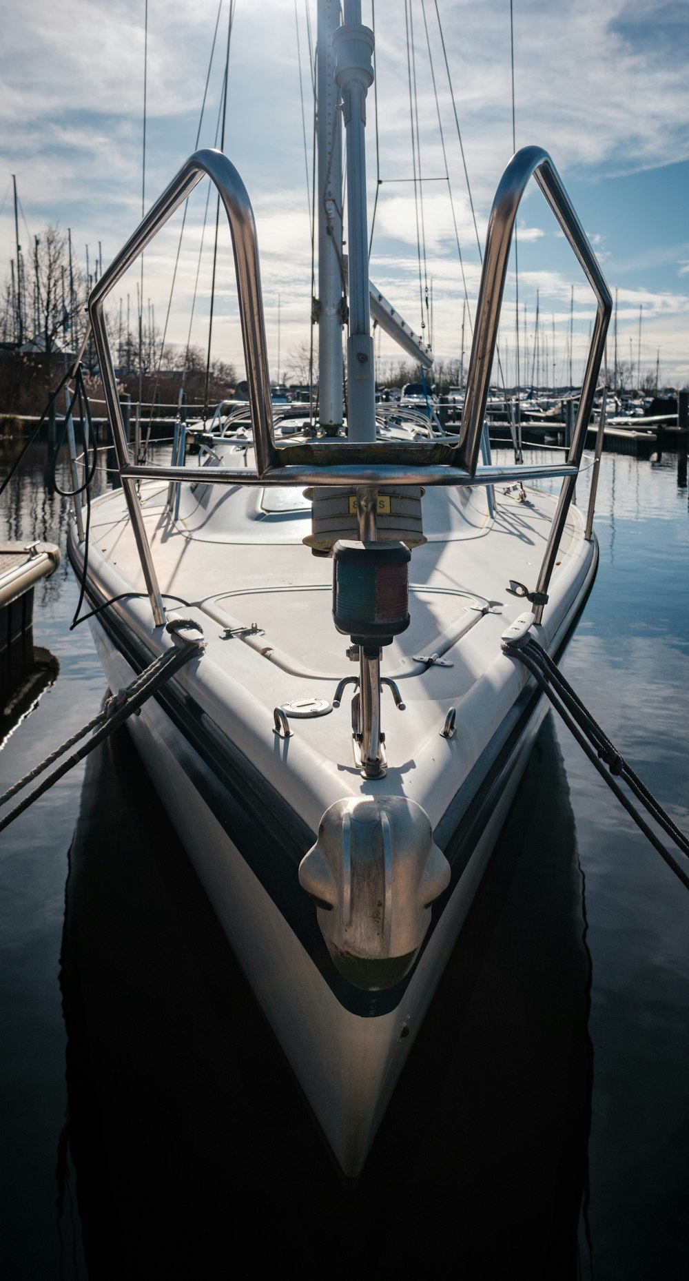 a sailboat docked in a harbor with a sky background