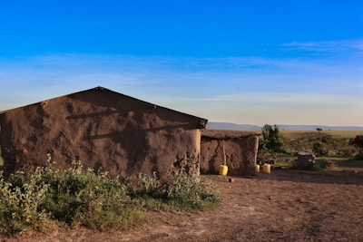 a small adobe building in the middle of a desert