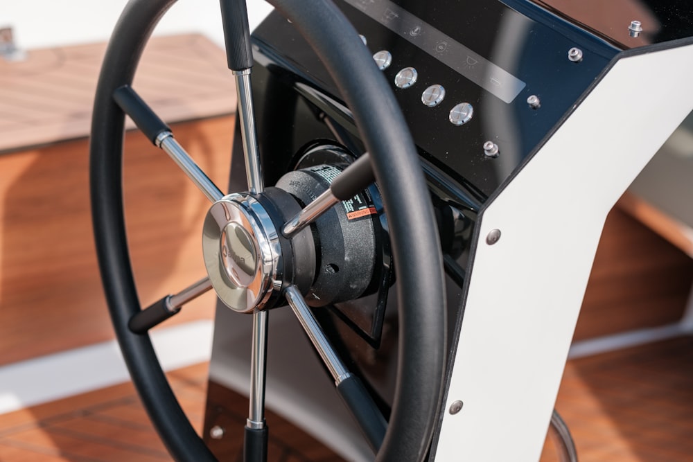 a steering wheel of a boat on a wooden deck