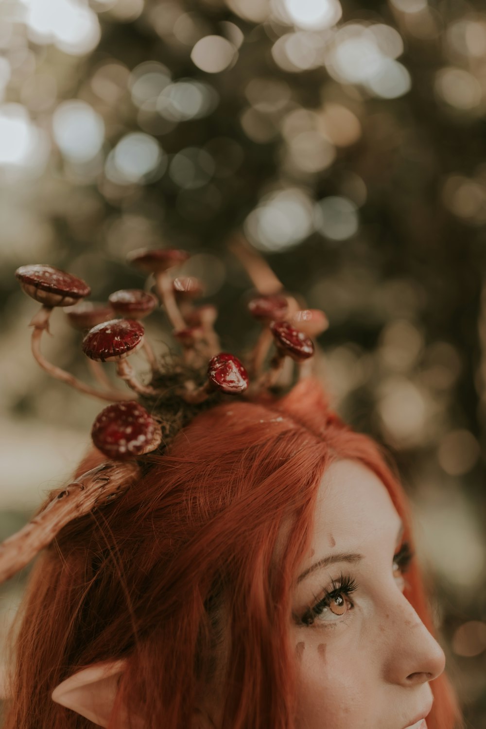 a woman with red hair wearing a flower crown