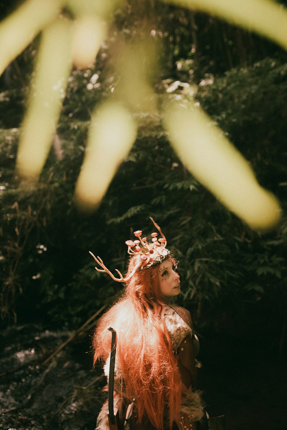 a woman with long red hair and a crown on her head