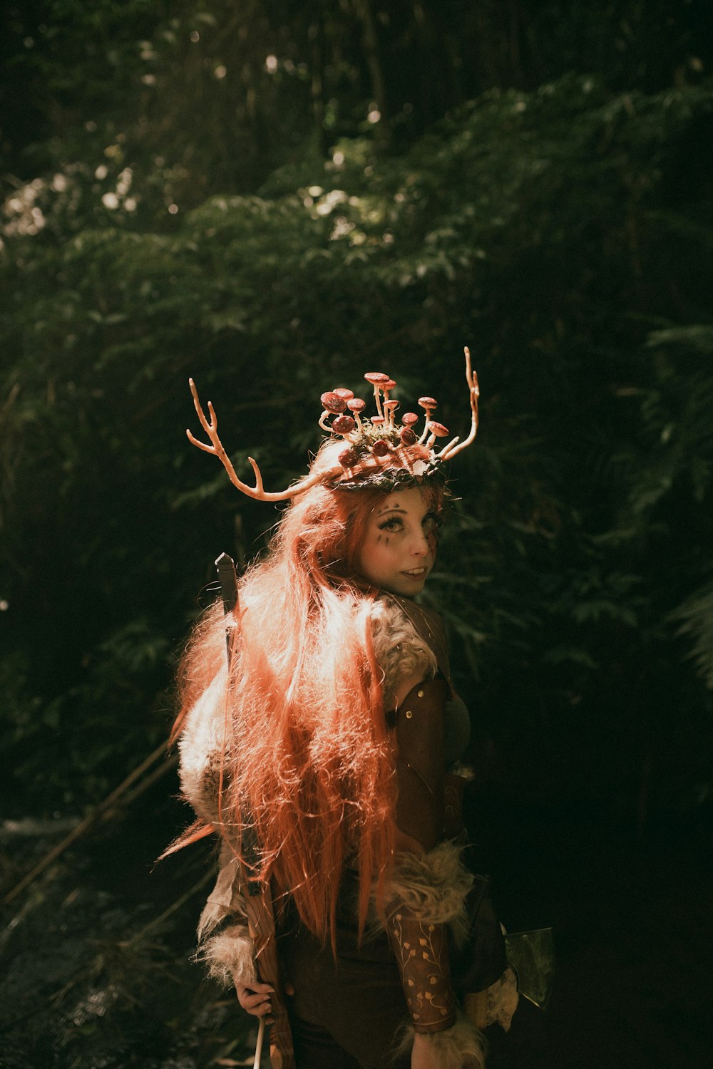 a woman with long red hair wearing a deer costume