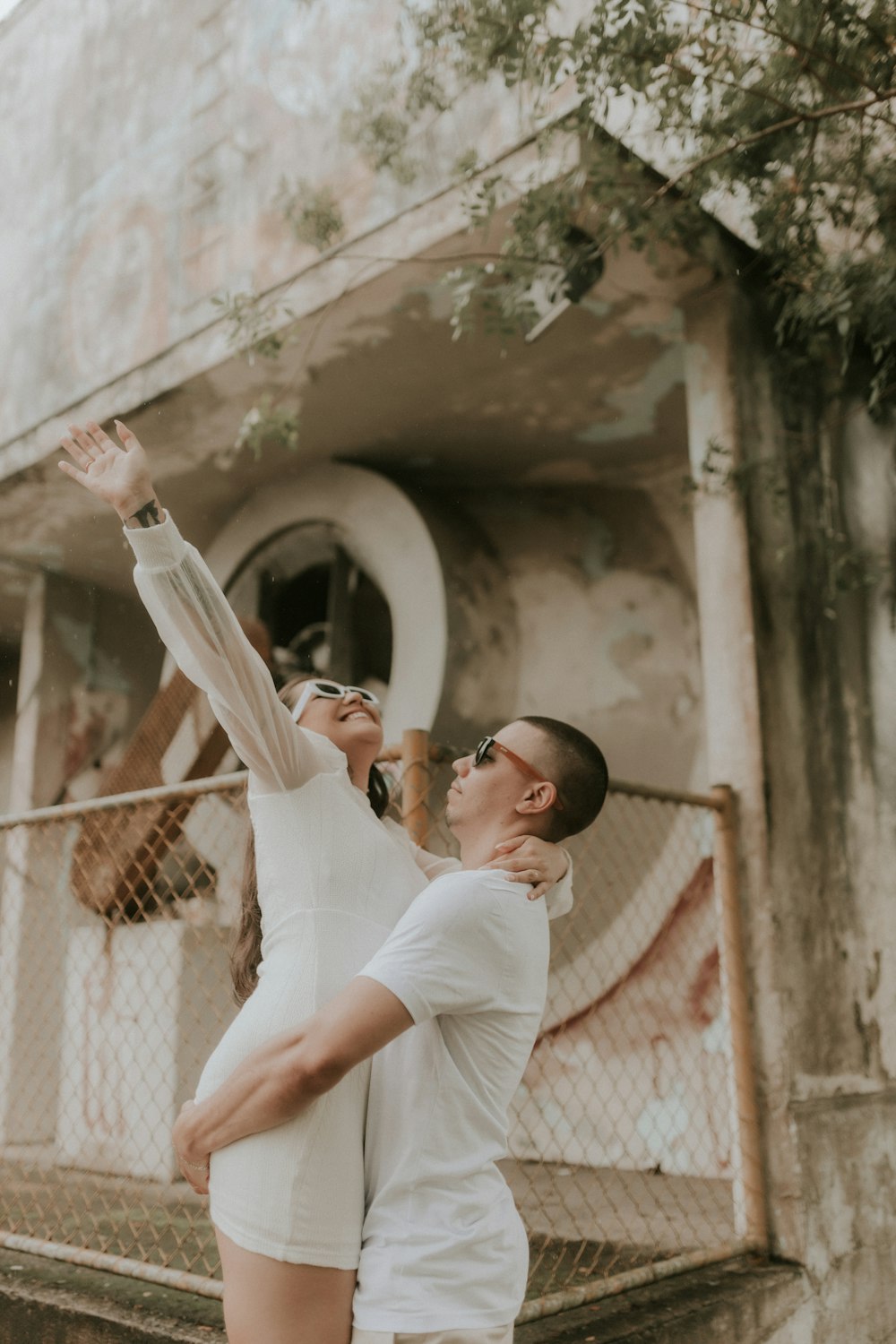 a man and a woman standing in front of a building