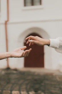 two people reaching out their hands to each other