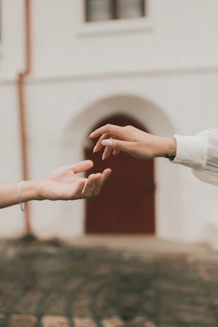 two people reaching out their hands to each other