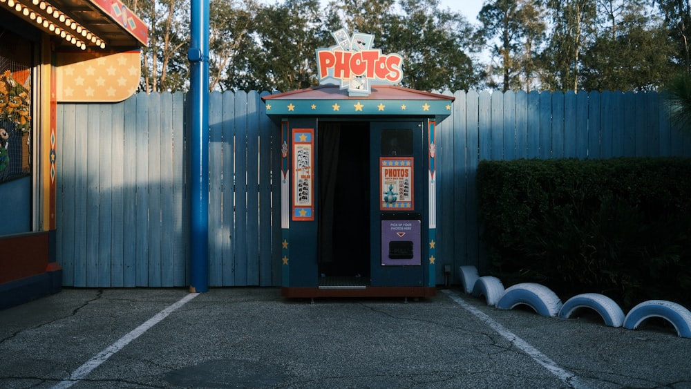 a phone booth in a parking lot next to a building