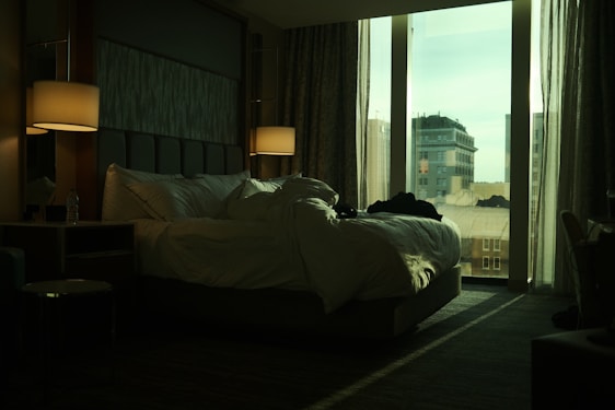 a bedroom with a large bed and a large window