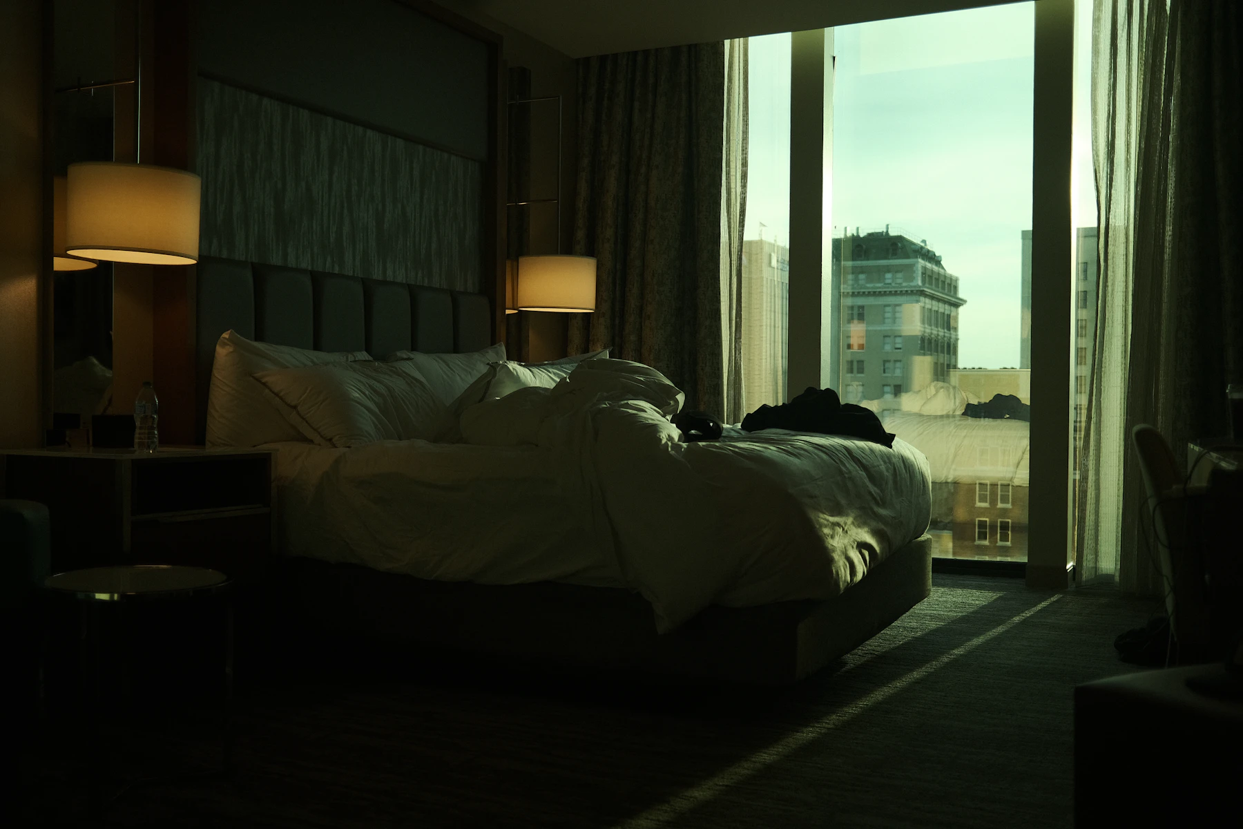 Sunlit hotel bedroom with a large window