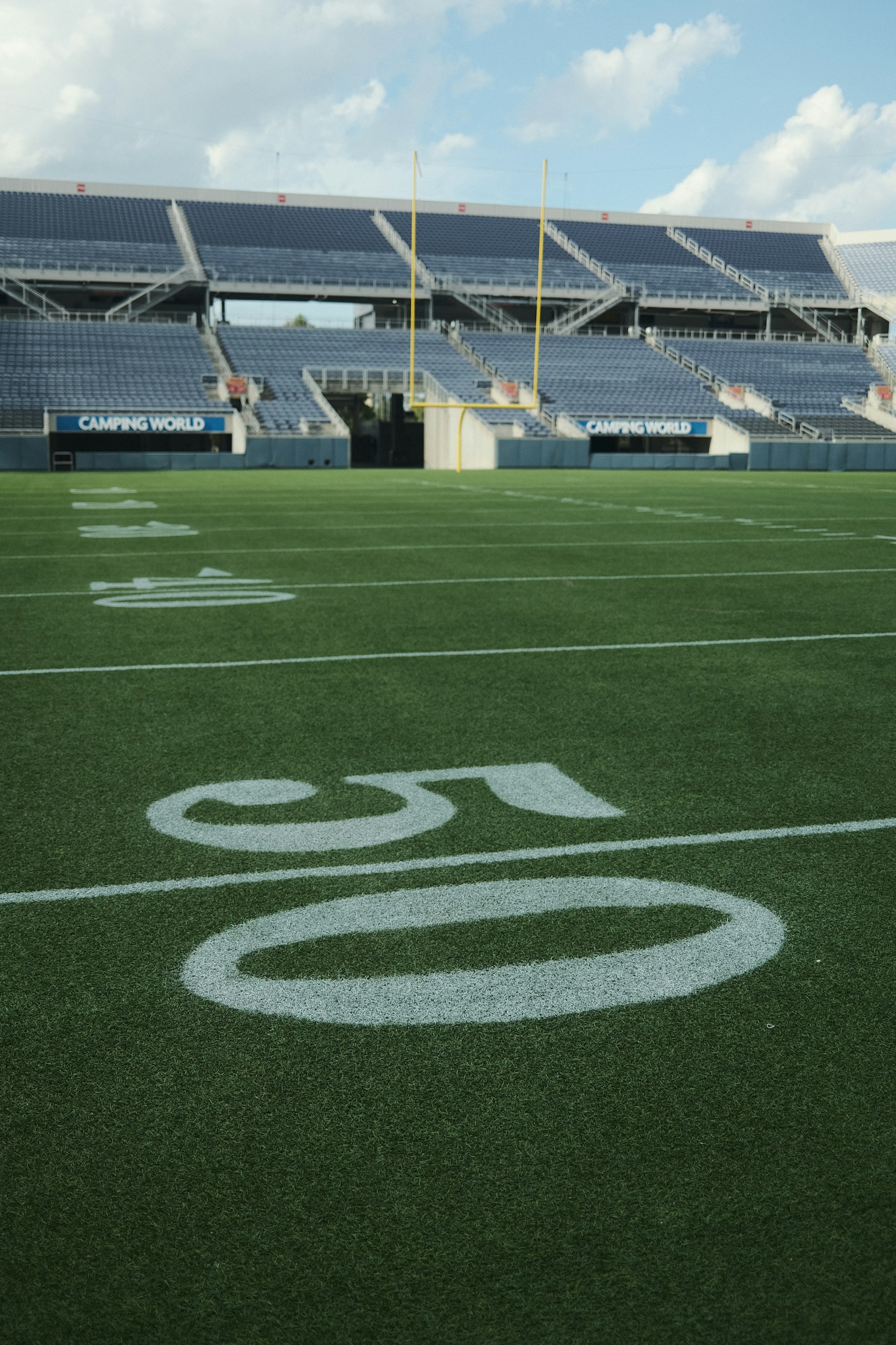 an empty football field with a sky background