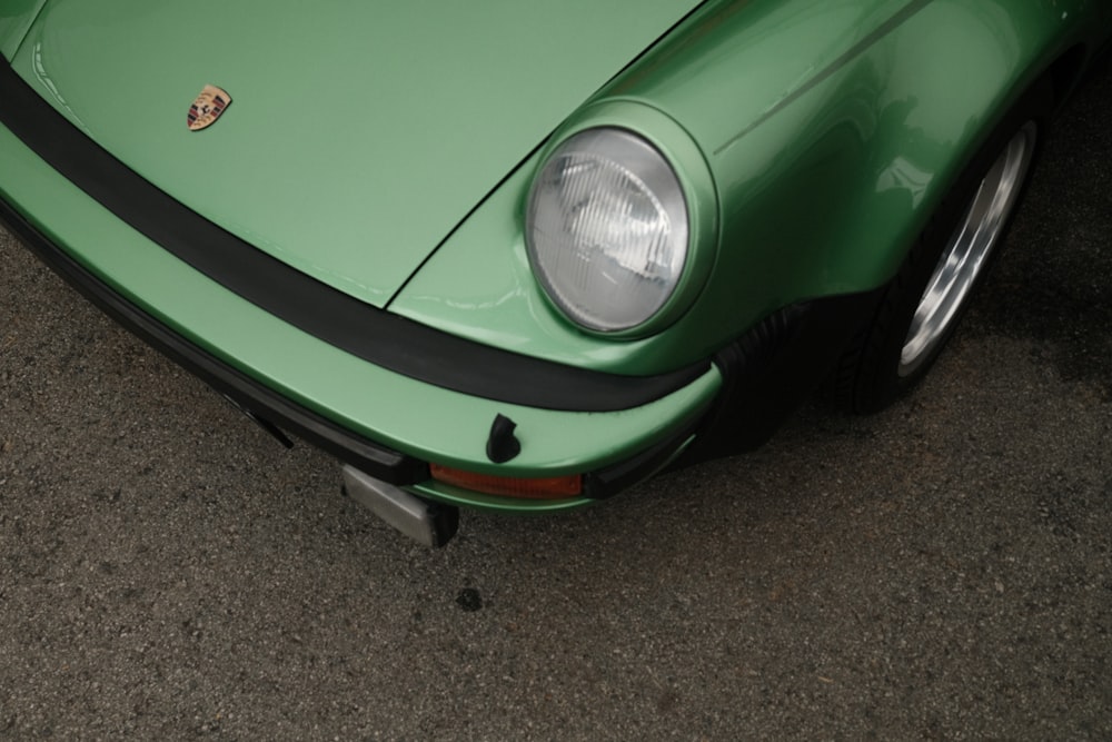 a close up of the front of a green sports car