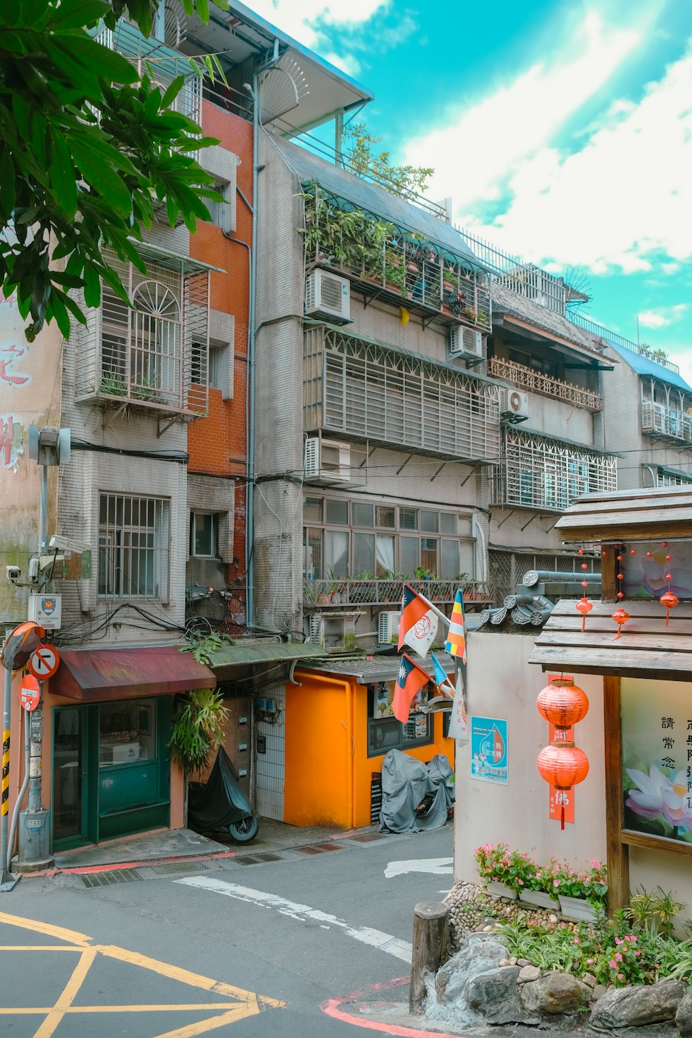 a building with a lot of orange lanterns hanging from it's roof