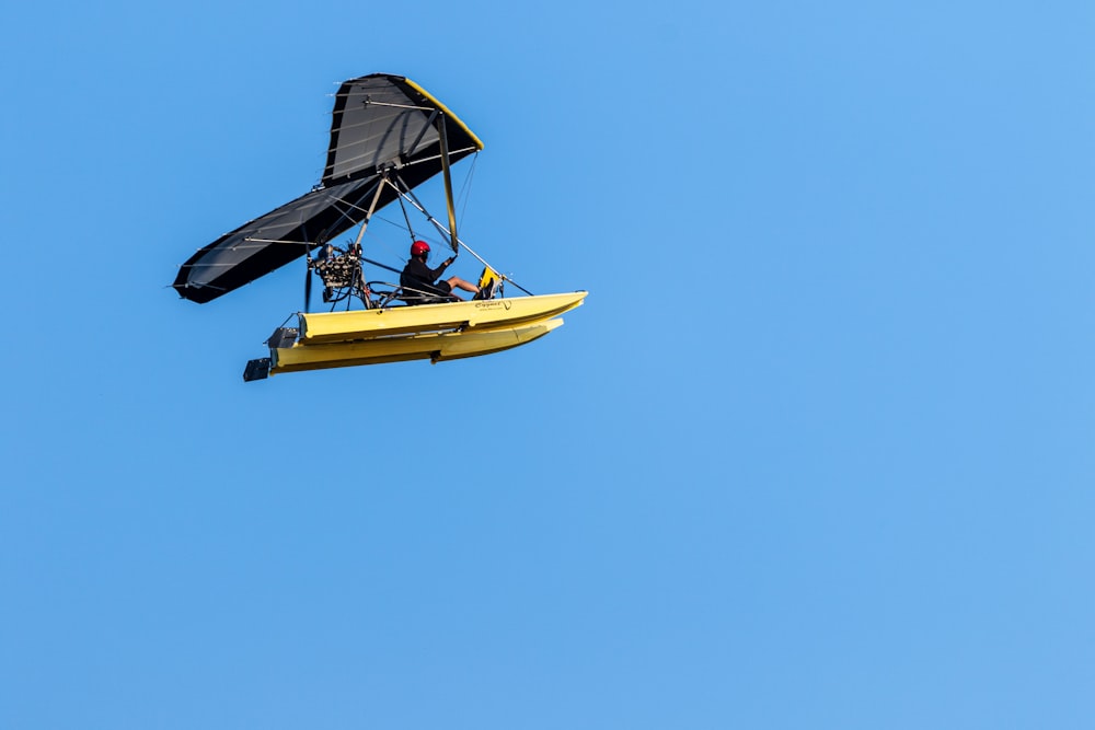 a man is flying a small plane in the sky