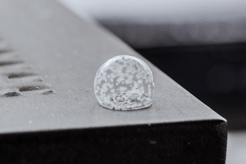 a piece of glass sitting on top of a metal table